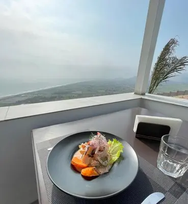 a plate of food sitting on a table in a window at Vista a Mar in Huaral