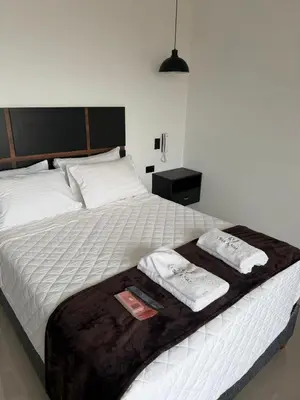a bedroom with a bed with two towels on it at Vista a Mar in Huaral