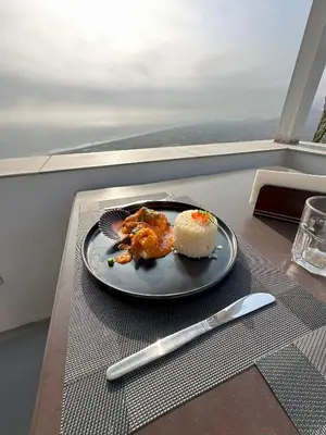 a plate of food on a table with a knife at Vista a Mar in Huaral