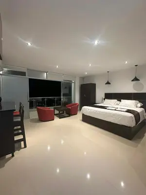 a bedroom with a bed and a desk and a television at Vista a Mar in Huaral