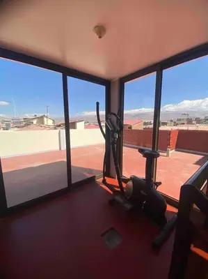 a room with a view of a gym with windows at Casa Elizabeth in Huancayo