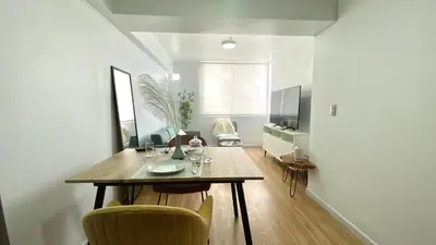 a dining room with a table and chairs in a room at Vista Brasil Dúplex in Lima
