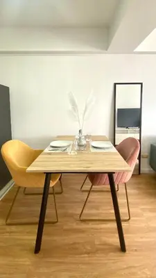 a wooden table with two chairs and a mirror at Vista Brasil Dúplex in Lima