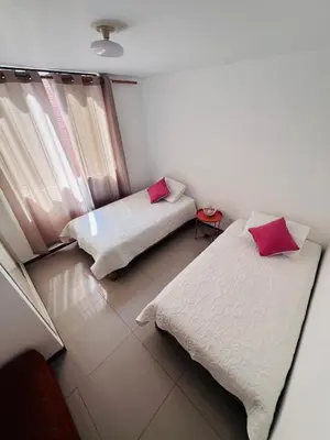 a room with two beds and a window at loft apartament residencial ICA in Ica