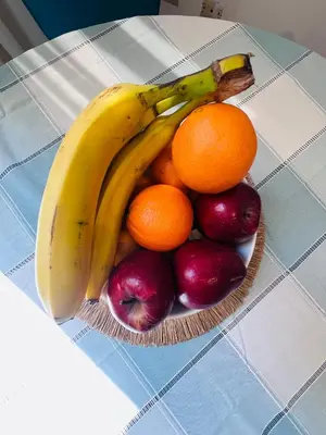 a bowl of fruit on a table with bananas oranges and apples at Loft Huacachina center ica in Ica