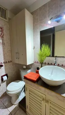 a bathroom with a white sink and a toilet at Loft Huacachina center ica in Ica