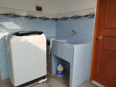 a small refrigerator in a kitchen with blue tiles at Habitación H3, TV y WIFI cerca a Barranco in Lima