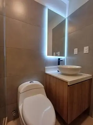 a bathroom with a white toilet and a sink at Luxurious Apartment Besso in Lima