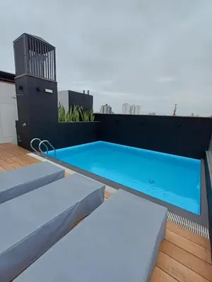 a swimming pool on the roof of a building at Luxurious Apartment Besso in Lima