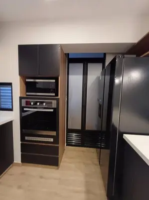 a kitchen with a stainless steel refrigerator and appliances at Luxurious Apartment Besso in Lima
