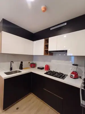 a kitchen with white cabinets and a stove top oven at Luxurious Apartment Besso in Lima