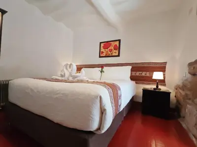 a bedroom with a bed with a stuffed animal on it at Afma Cusco in Cusco