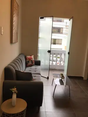a living room with a couch and a table at Suite 201 in Lima