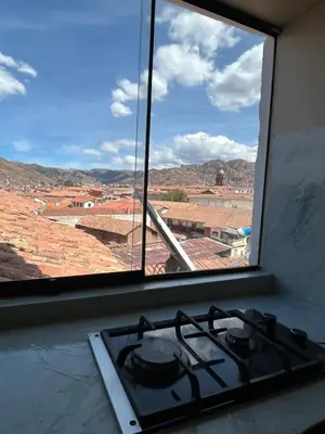 a stove top oven in a kitchen with a window at Duplex panorámico in Cusco