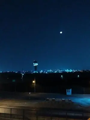 a view of an airport with a control tower at night at Wasi de Sophia in Lima