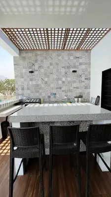 a kitchen with a large white counter and chairs at Cieneguilla Dreams in Cieneguilla