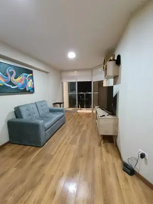 a living room with a blue couch and a television at Departmento Campo de Marte in Lima