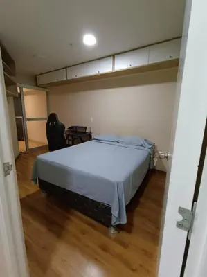 a bedroom with a large bed in a room with a wooden floor at Departmento Campo de Marte in Lima