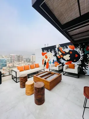 a living room with couches and a mural on a wall at MONTERRICO POLO APARTS #20 - DEPARTAMENTO DELUXe FRENTE EMBAJADA USA in Lima