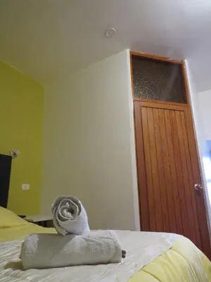 a room with a bed with a towel on it at La Casa de Abril Cusco in Cusco