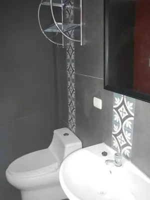 a bathroom with a white toilet and a sink at Blue Shark Apartments in San Bartolo