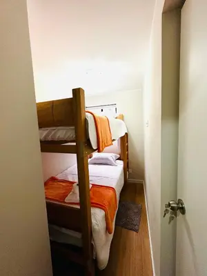 a small room with two bunk beds in it at Alojamiento Mama Ocllo in Lima