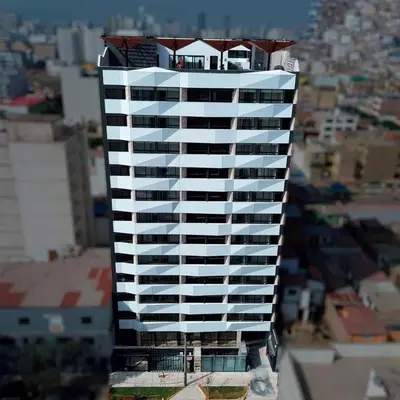a tall building with a house on top of it at Alojamiento Mama Ocllo in Lima