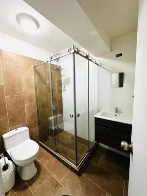 a bathroom with a shower and a toilet and a sink at Alojamiento Mama Ocllo in Lima