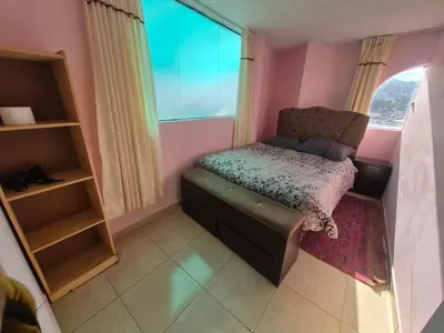 a small room with a chair and a window at Casa Mirador San Blas II in Cusco