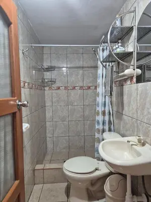 a bathroom with a toilet and a sink at MaKePal Guest House in Cusco