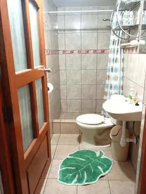 a bathroom with a toilet and a sink at MaKePal Guest House in Cusco