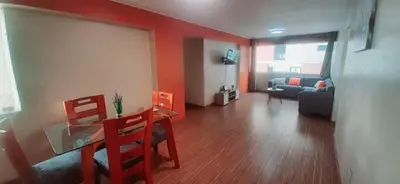 a living room with a table and chairs and a couch at Alojamiento Miraflores 3 habitaciones in Lima