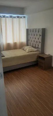 a bedroom with a large bed with a window at Alojamiento Miraflores 3 habitaciones in Lima