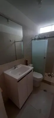 a bathroom with a sink and a toilet and a mirror at Alojamiento Miraflores 3 habitaciones in Lima