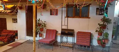 a group of chairs sitting outside of a house at Hospedaje Rosita INN in Cusco