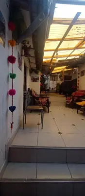 a room with stairs in a building with red and green decorations at Hospedaje Rosita INN in Cusco