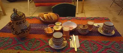 a table with food and a basket of bread at Hospedaje Rosita INN in Cusco