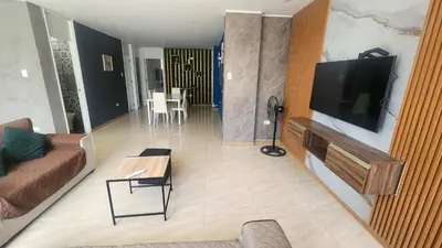 a living room with a couch and a flat screen tv at Departamento exclusivo ica in Ica
