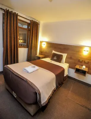 a hotel room with a large bed in a room at San Francisco Pardo Hotel in Cusco