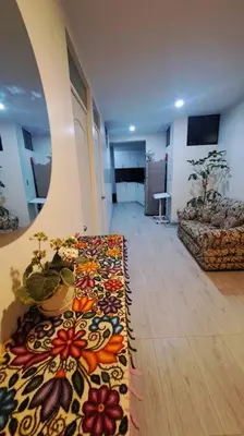 a living room with a rug on the floor at Habitaciones en la Casa de Dora, 4to y 5to piso in Ayacucho