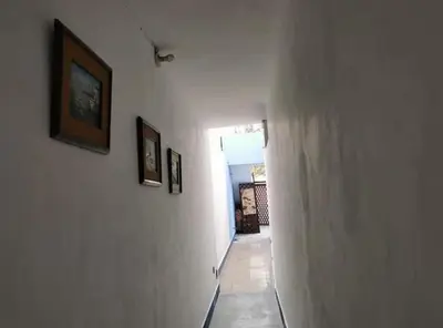 a hallway with three pictures on the walls and a hallwayngthngthngthngthngth at Hospedaje interno surco in Lima