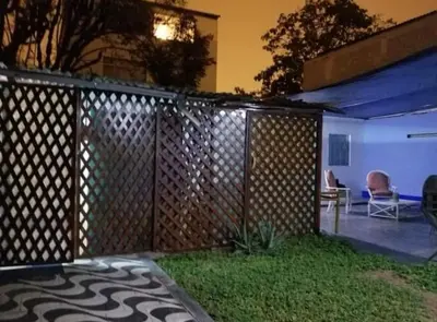 a wooden fence in front of a yard at night at Hospedaje interno surco in Lima