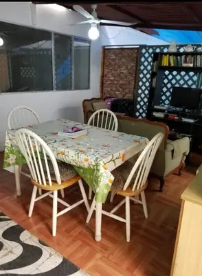a dining room table and chairs with a table and a couch at Hospedaje interno surco in Lima