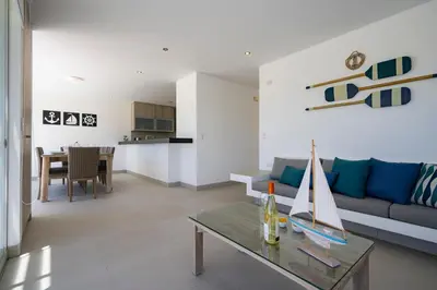 a living room with a couch and a table at Sotavento Beach Homes by Vibrant in Paracas