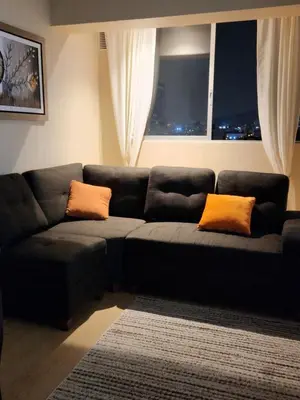a living room with a couch and a window at TOWEr2 in Lima
