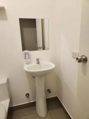 a white sink in a bathroom with a mirror at TOWEr2 in Lima
