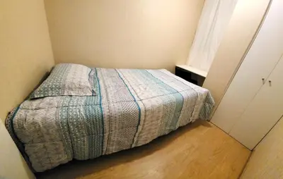 a bedroom with a bed in a room with a window at TOWEr2 in Lima
