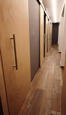 a row of elevators in a hallway with wooden floors at Casa sabina aeropuerto plus in Lima