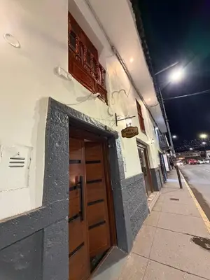 a building with a door on the side of a street at Redys House in Cusco