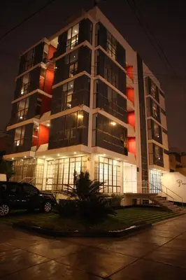 a tall building with a car parked in front of it at Park Hotel Lima in Lima